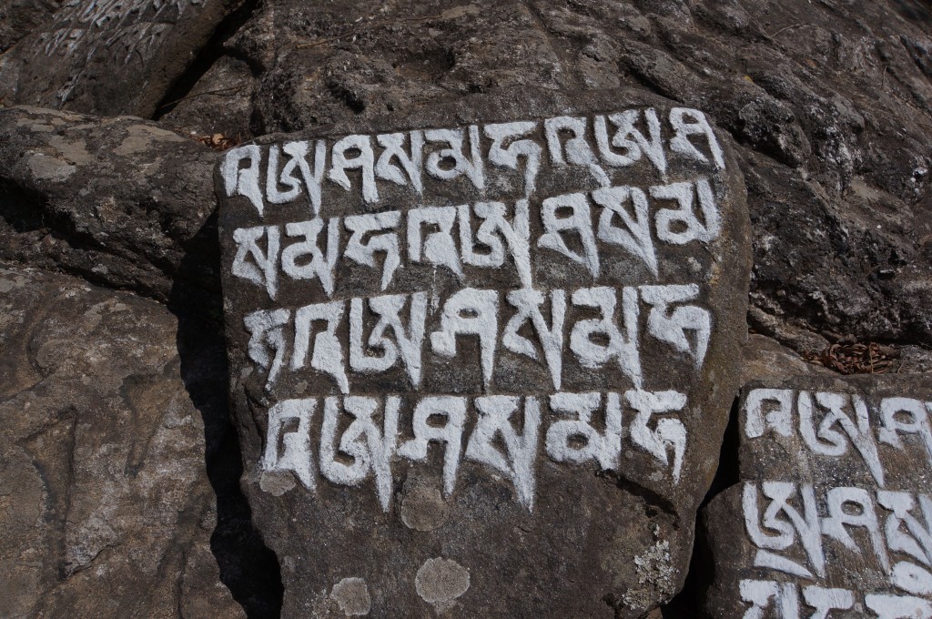 The influence of Buddhism is evident everywhere, including prayers carved and painted into the very living rock.
