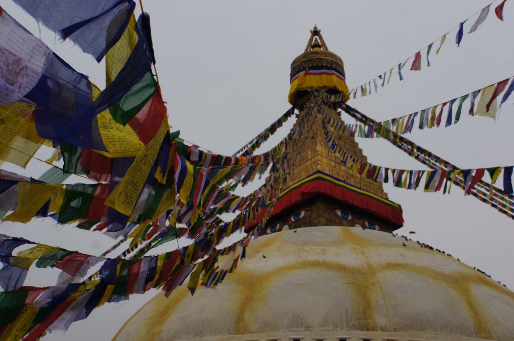 Traditional Tibetan prayer flags stream from the top of the temple.