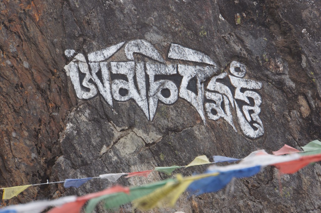 Prayer carved into the rock above town.