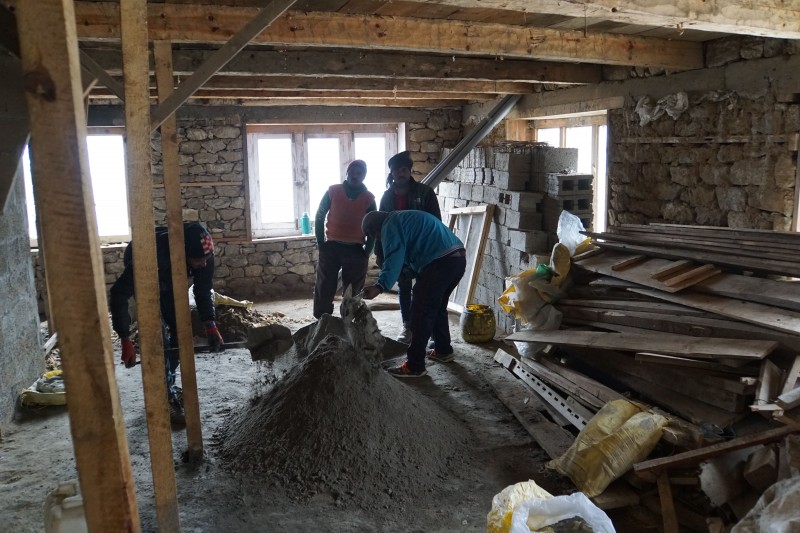 The basement, intended for storage, being sealed with concrete mixed by hand.