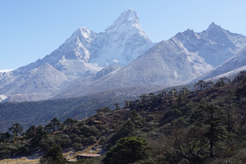 Ama Dablam and prayer flags on a ridge above the village.  