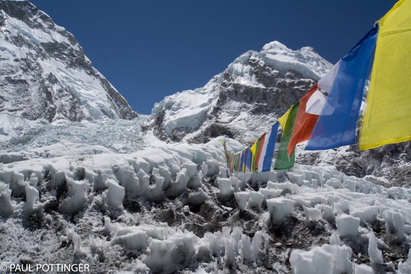 These prayer flags are a hassle during our climbs, because they swing low enough to catch our ice axes strapped to our backpacks. During the day, though, they certainly are beautiful.
